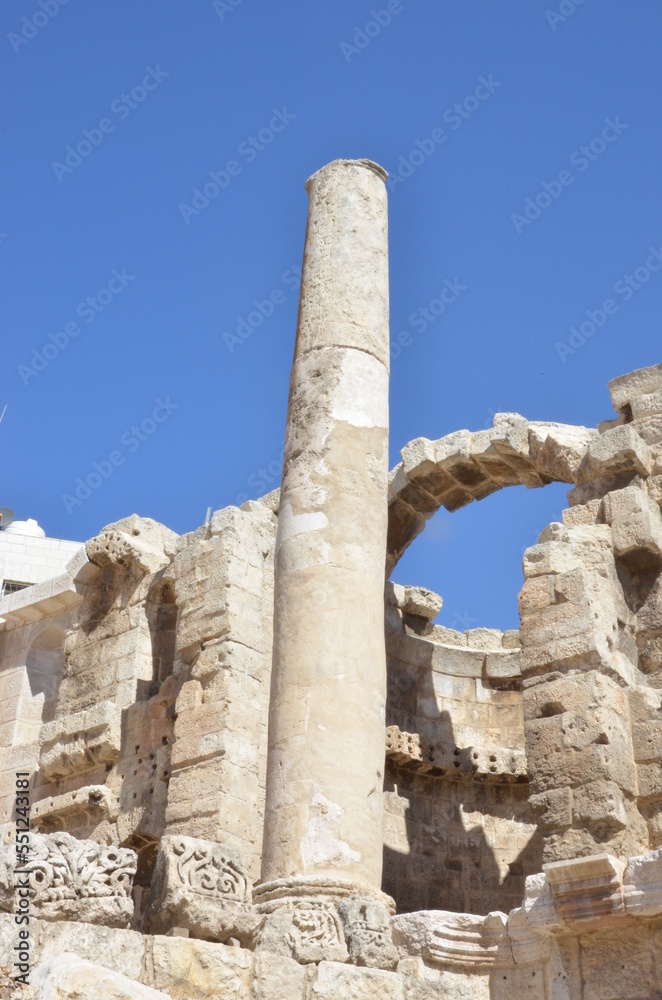 Ancient ruins of Greek and Roman buildings in the Citadel of Amman on a bright sunny day.