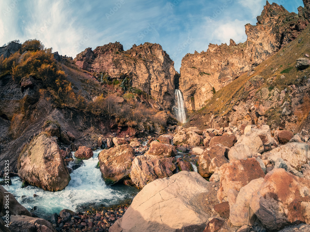 Obraz premium Scenic autumn landscape with vertical big Sultan waterfall at mountain top in sunshine in the Jila-Su tract. Kabardino-Balkaria. Russia, Caucasus. High falling water in Northern Elbrus region.