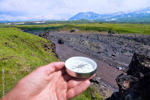 The right compass is always needed for travelers, adequate course. Mountaineering trekking through the mountains and river valleys of volcanic origin of Kamchatka photo