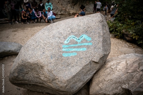 Art on of boulders at Eaton Canyon hiking trails with wild plants photo