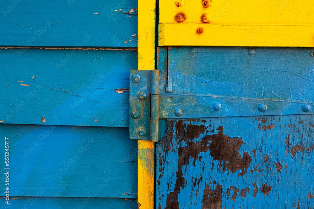 old rusty yellow and blue metal door old rusty yellow and blue metal door