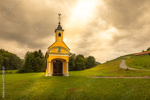 Scenery chapel along the south Styrian vine route named suedsteirische weinstrasse in Austria at sunset, Europe, Glanz, Austria. photo