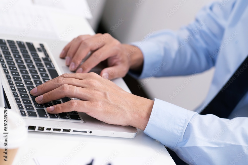 Business man working by using laptop computer Hands typing on a keyboard. Professional investor working new start up project. business planning in office. Technology business