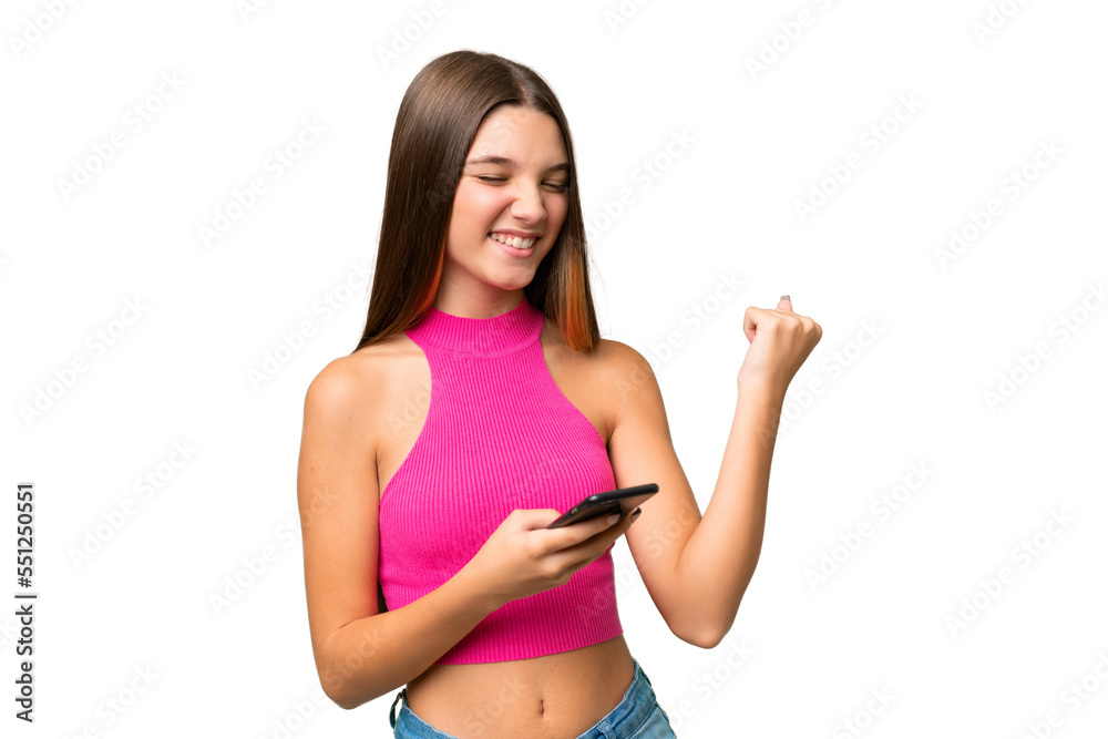 Teenager caucasian girl over isolated background with phone in victory position Teenager caucasian girl over isolated background with phone in victory position