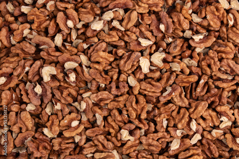 background of peeled walnuts close up top view