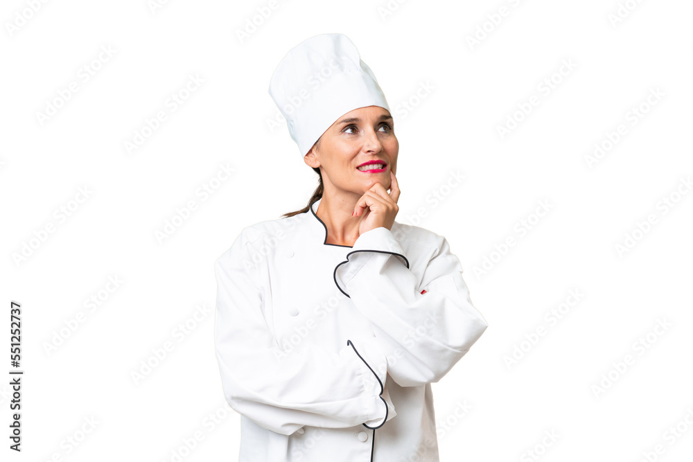 Middle-aged chef woman over isolated background thinking an idea while looking up
