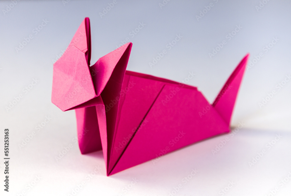Pink paper cat origami isolated on a white background Pink paper cat origami isolated on a white background