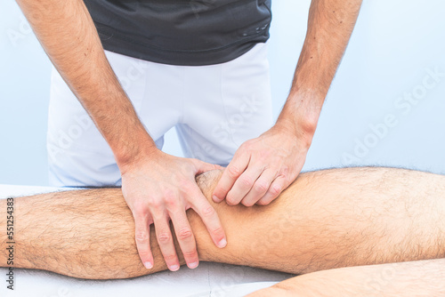 Knee patella mobilization by a physical therapist photo