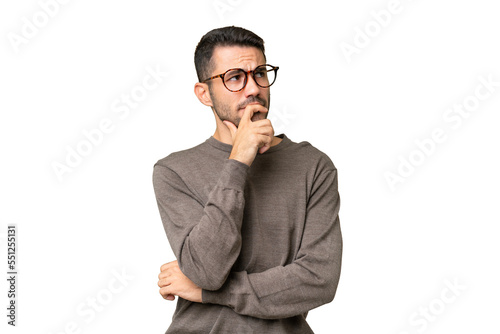Young handsome caucasian man over isolated background having doubts and with confuse face expression photo