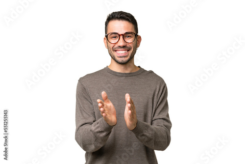 Young handsome caucasian man over isolated background applauding after presentation in a conference