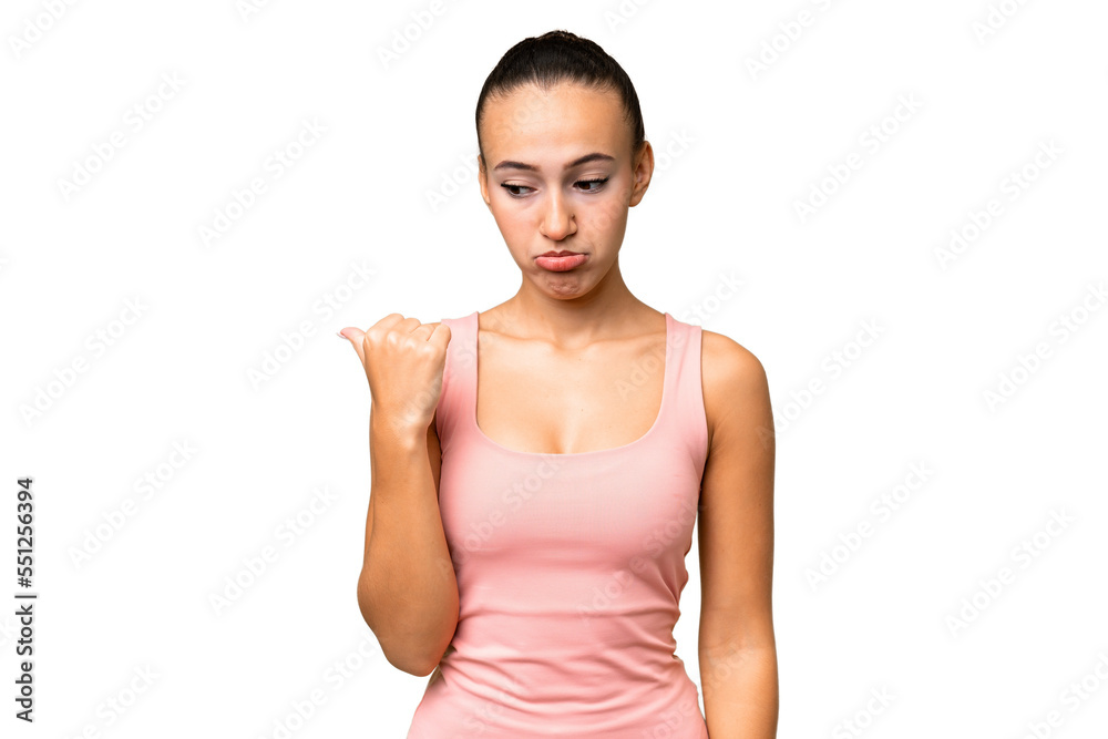 Young Arab woman over isolated background unhappy and pointing to the side Young Arab woman over isolated background unhappy and pointing to the side