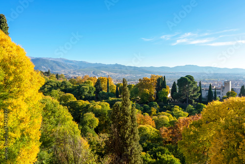 Green gardens of Alhambra on mountains peak covered by snow in Granada, Spain on November 26, 2022