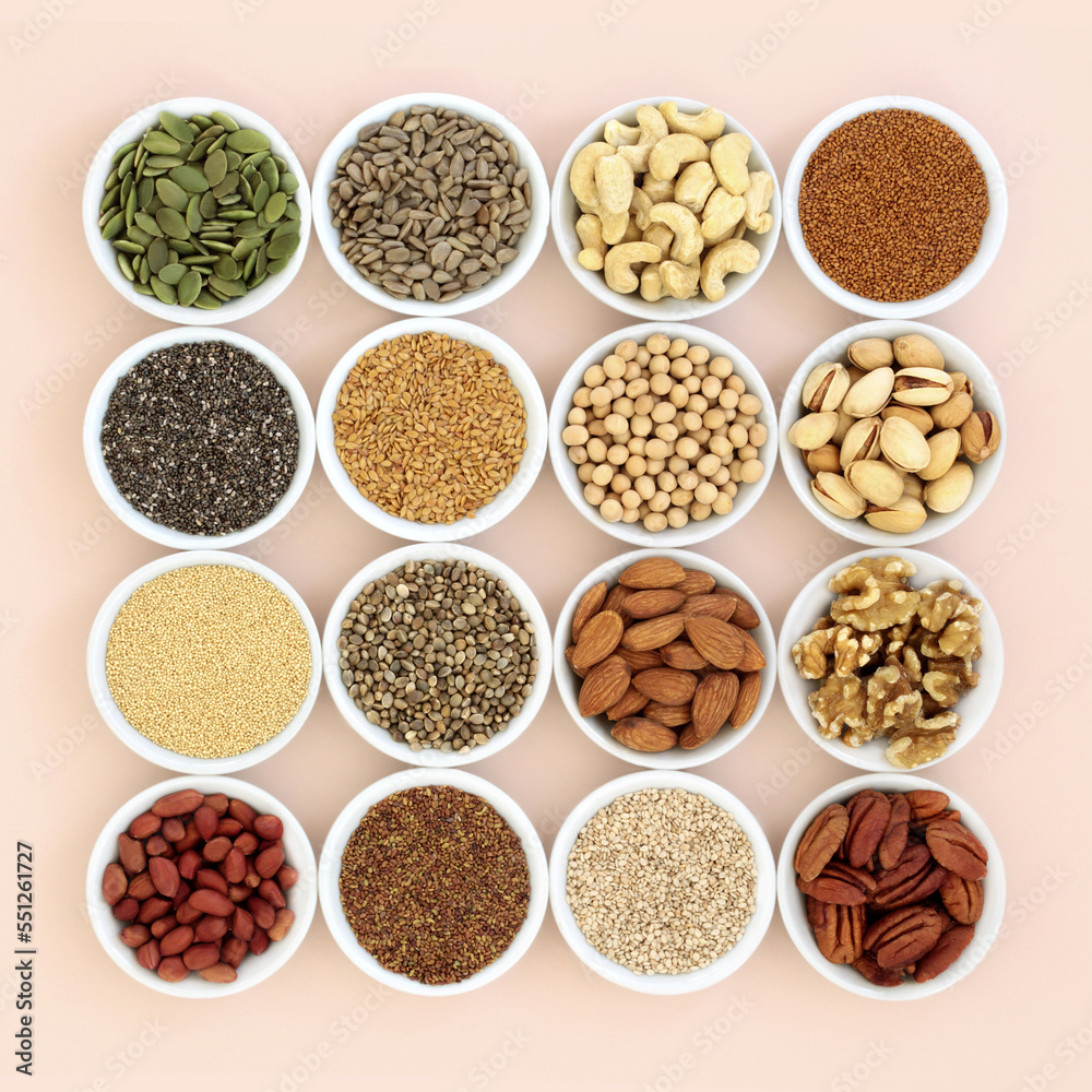 Plant based health food high in lipids. Ingredients contain unsaturated fats for healthy heart and cholesterol levels with nuts, seeds, legumes and grain. On neutral background.