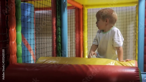 A little boy of 4 years old is playing in an entertainment complex, climbing various soft figures and going through mazes. Fun entertainment for children. High quality 4k footage photo