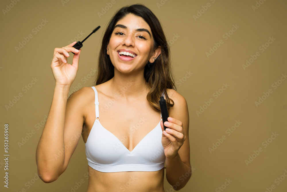 Gorgeous woman putting on makeup and smiling Gorgeous woman putting on makeup and smiling