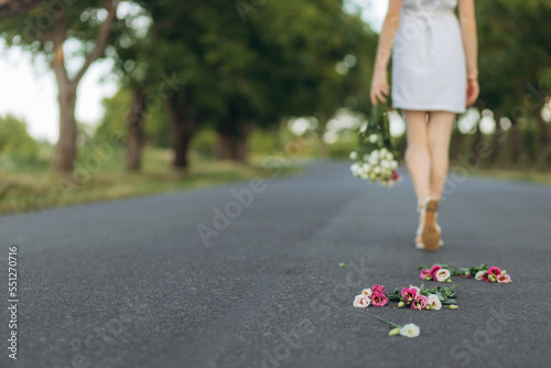 close-up of a bouquet of flowers on the road. Divorce. Girl after divorce with flowers