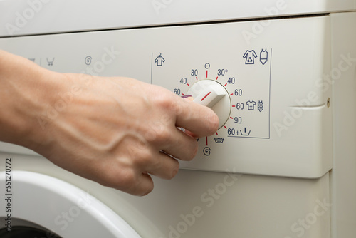 a person chooses a washing mode with a switch.