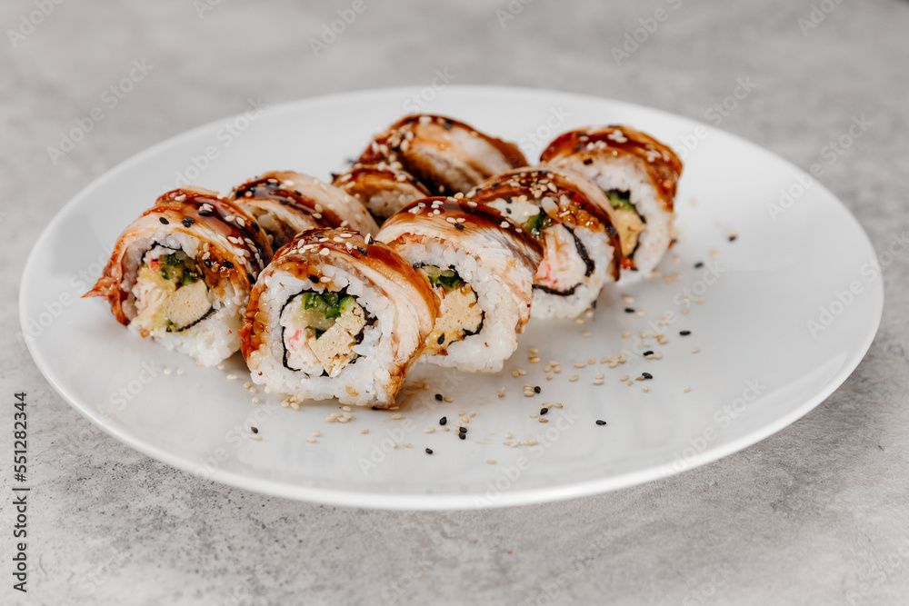 Eight servings of shrimp and eel sushi on a white plate. Eight servings of shrimp and eel sushi on a white plate.