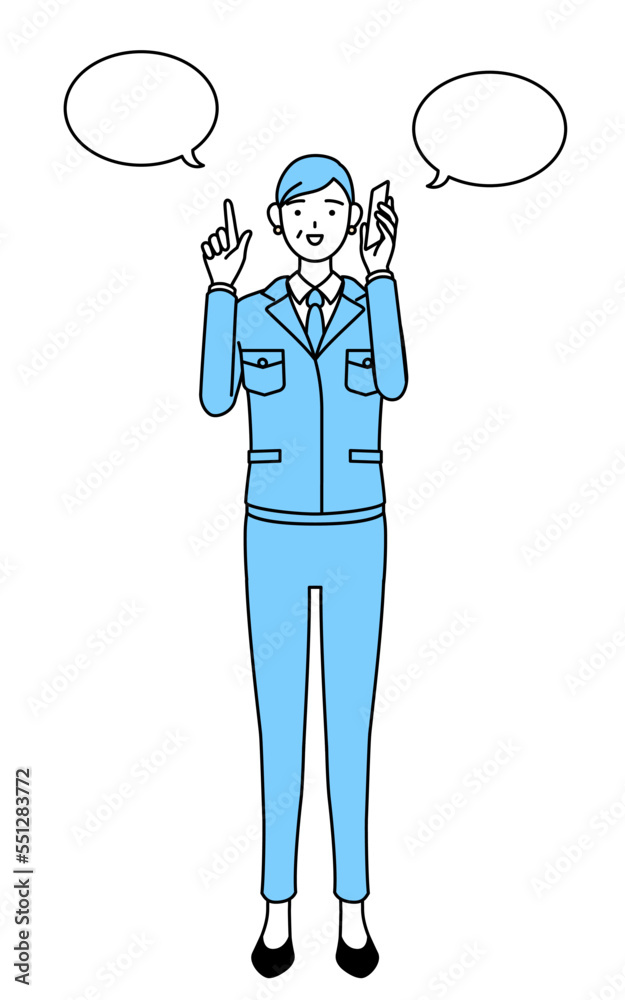 電話をしながら指さしをする作業着を着たシニア女性（経営者、管理職、工場長）