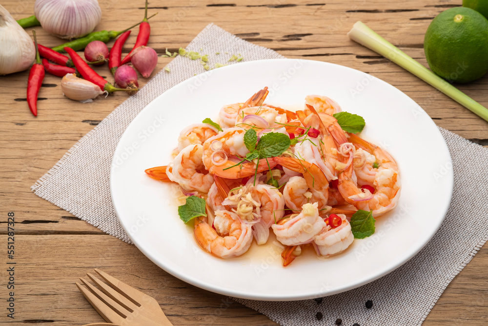 Spicy salad with shrimp,Thai boiled shrimps with lemongrass in chilli lime sauce in white plate Spicy salad with shrimp,Thai boiled shrimps with lemongrass in chilli lime sauce in white plate