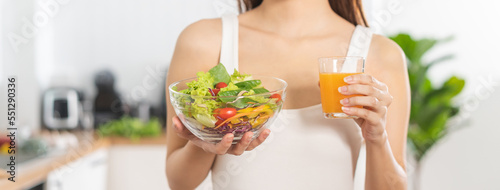 Diet, Dieting, pretty asian young woman or girl smiling, holding glass of orange juice and mix vegetables, green salad bowl. eat food is low fat good healthy. Nutritionist weight loss health person.