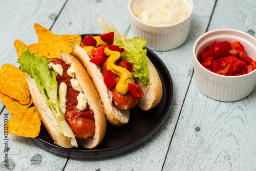 Hot dogs with different toppings on a table