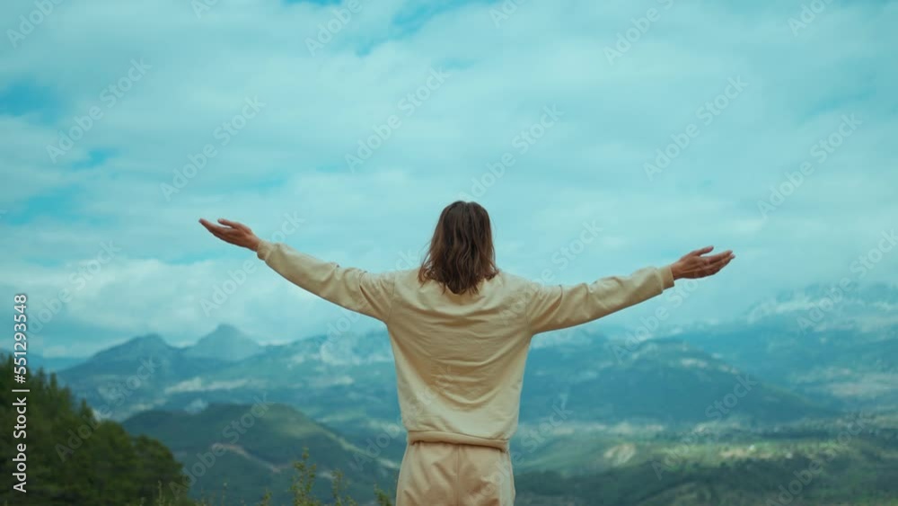 rear view inspired Woman Standing outdoors on mountains background and rising Her Arms. woman traveler enjoying beauty of nature and wilderness outdoors in Turkey. Travel vacation concept rear view inspired Woman Standing outdoors on mountains background and rising Her Arms. woman traveler enjoying beauty of nature and wilderness outdoors in Turkey. Travel vacation concept