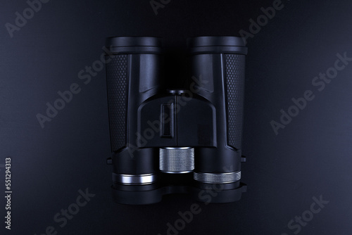 New binoculars isolated on black background. Flat lay, top view