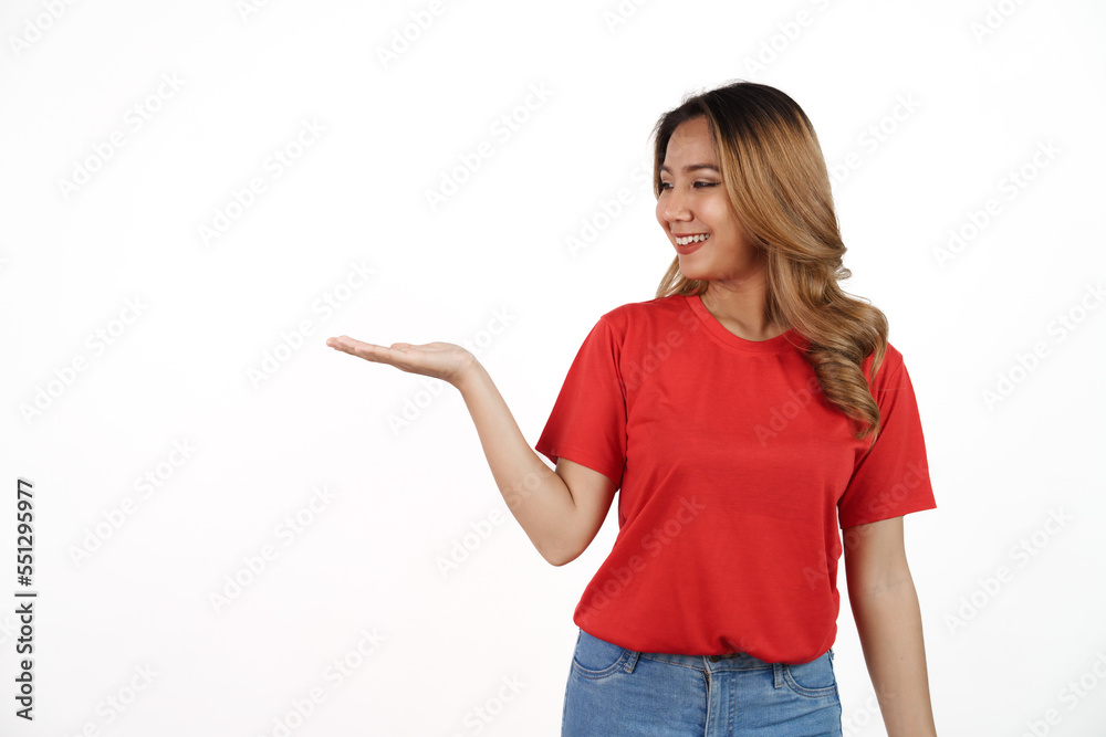Studio shot of pretty Asian woman with red t-shirt isolated on white background. Palm up or holding product