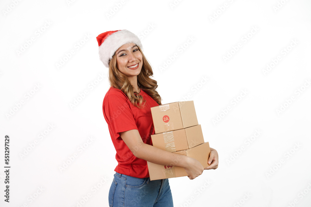 Happy asian woman in santa hat and red t-shirt isolated on white background. holding a box of goods Happy asian woman in santa hat and red t-shirt isolated on white background. holding a box of goods
