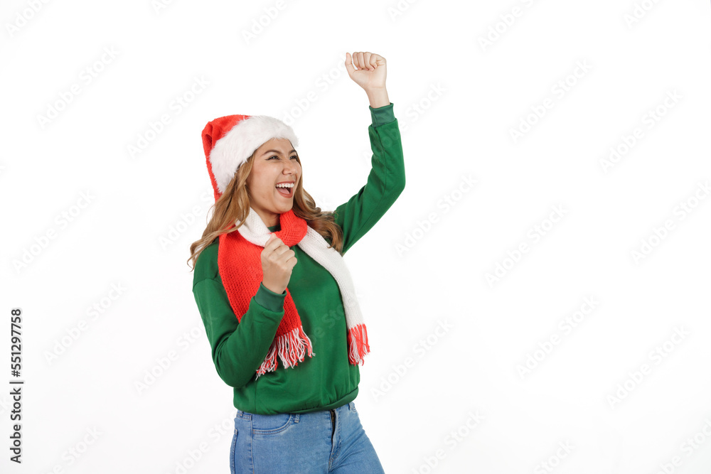 Attractive excited asian female in green sweater with santa hat on christmas isolated on white background.