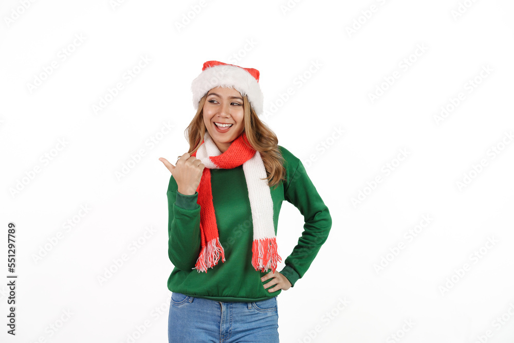 Attractive excited asian female in green sweater with santa hat on christmas isolated on white background. Attractive excited asian female in green sweater with santa hat on christmas isolated on white background.