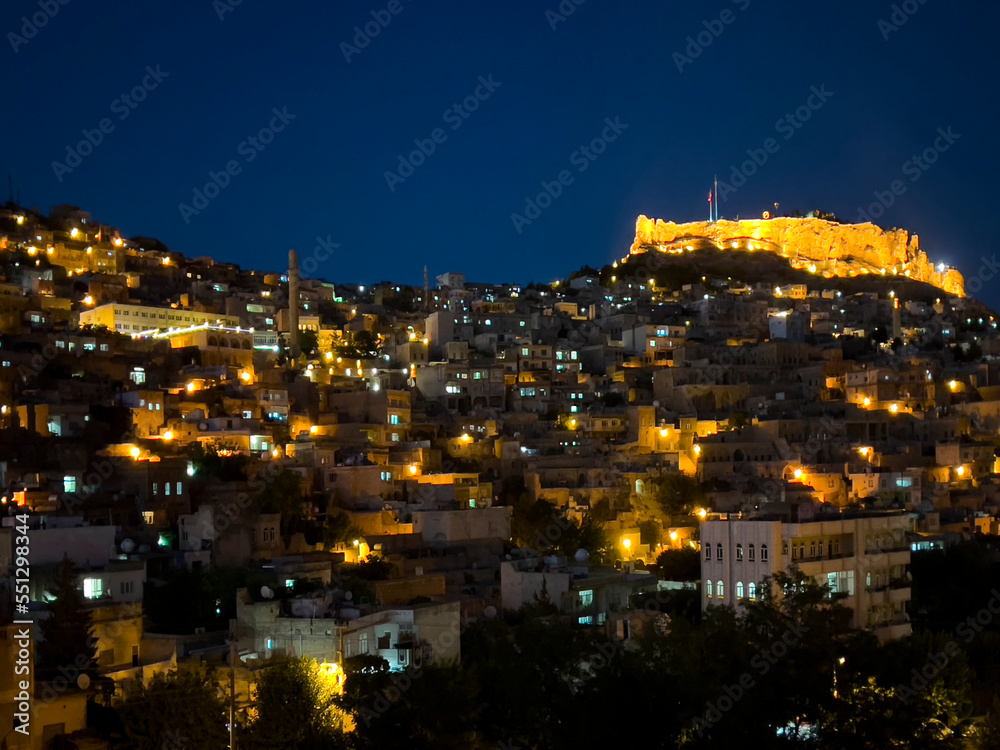 Old Mardin castle and city lights at night