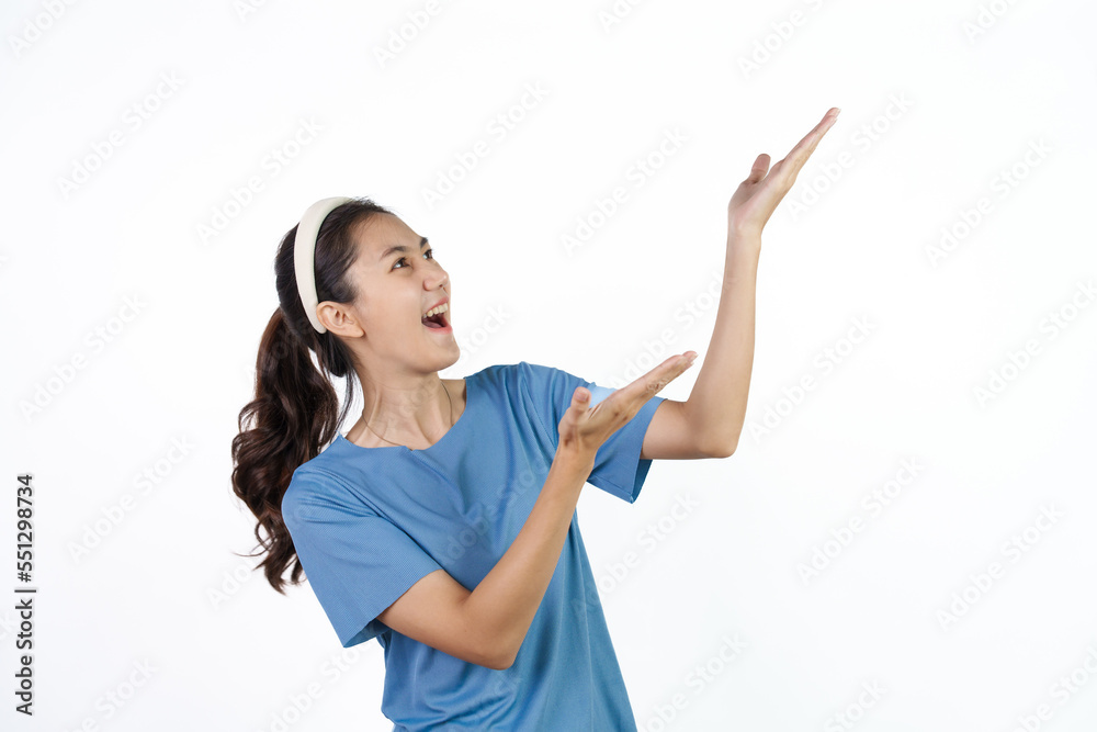 Beautiful Asian woman in blue t-shirt isolated on white background. Palm up Beautiful Asian woman in blue t-shirt isolated on white background. Palm up