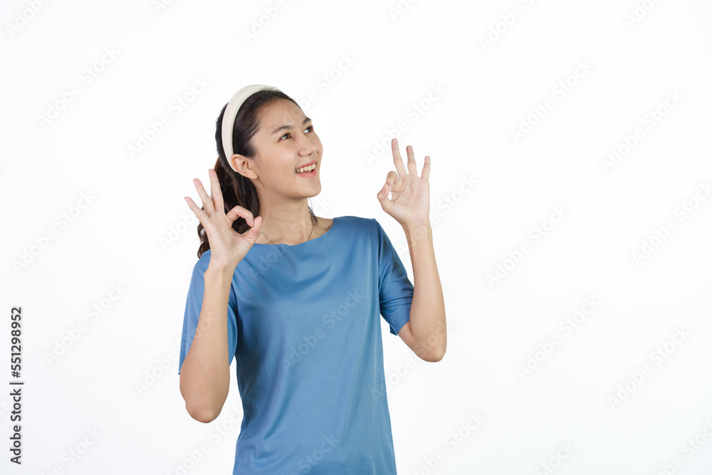 Beautiful Asian woman in blue t-shirt isolated on white background. ok Beautiful Asian woman in blue t-shirt isolated on white background. ok