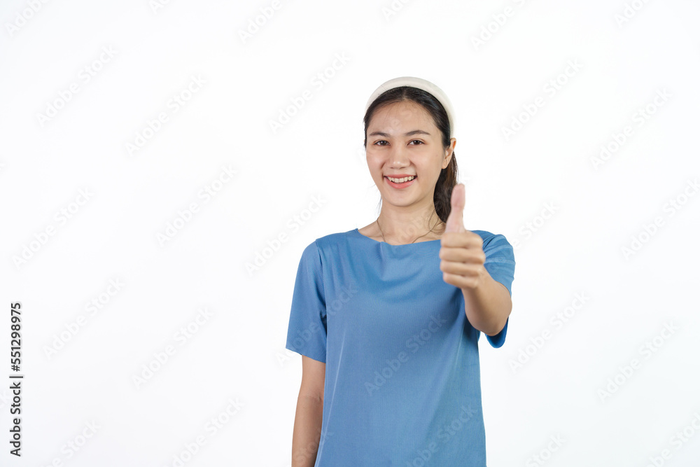 Beautiful Asian woman in blue t-shirt isolated on white background. Thumb up Beautiful Asian woman in blue t-shirt isolated on white background. Thumb up