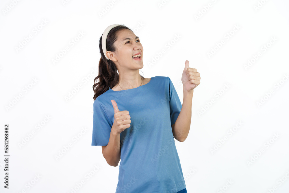 Beautiful Asian woman in blue t-shirt isolated on white background. Thumb up Beautiful Asian woman in blue t-shirt isolated on white background. Thumb up