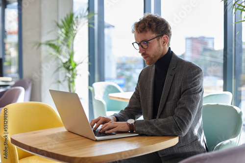 Pensive copywriter typing using laptop computer working freelance project online sitting at workplace. Successful business concept  © Maria Vitkovska