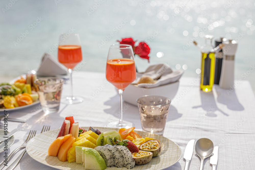 Luxury breakfast table beautiful tropical sea sky background. Idyllic romantic morning love couples time at summer holiday. Honeymoon romance vacation concept. Travel and lifestyle, destination dining Luxury breakfast table beautiful tropical sea sky background. Idyllic romantic morning love couples time at summer holiday. Honeymoon romance vacation concept. Travel and lifestyle, destination dining