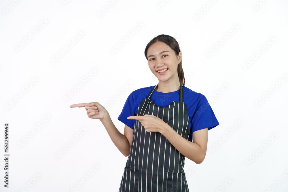 Excited asian coffee shop SME owner asian woman wearing blue t-shirt and black apron isolated on white background. Pointing Excited asian coffee shop SME owner asian woman wearing blue t-shirt and black apron isolated on white background. Pointing