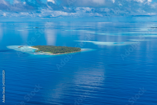 Maldives paradise island. Tropical aerial landscape, seascape with coral reef and atolls, amazing blue sea lagoon bay. Exotic tourism destination, summer vacation background. Idyllic aerial travel