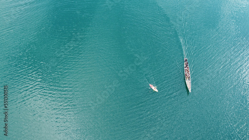 Aerial view from a drone of Thai traditional longtail fishing boat and kayak . Top view. © neonshot