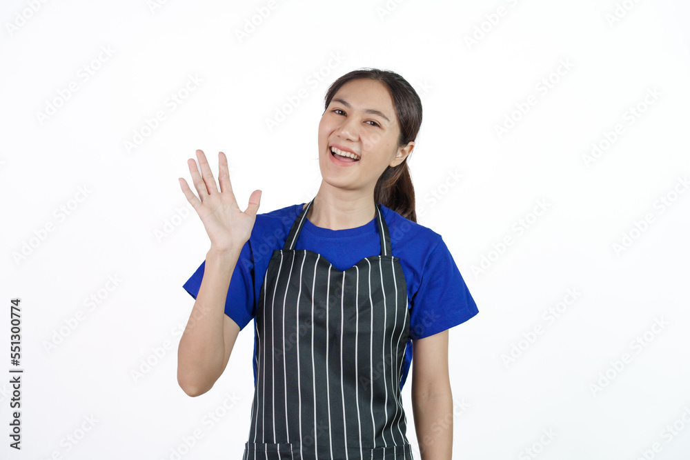 Excited asian coffee shop SME owner asian woman wearing blue t-shirt and black apron isolated on white background. Hand wave Excited asian coffee shop SME owner asian woman wearing blue t-shirt and black apron isolated on white background. Hand wave