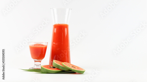 Papaya smoothie in glass jar and glasses on white background diet vegetarian healthy and freshness drink concept soft and selective focus