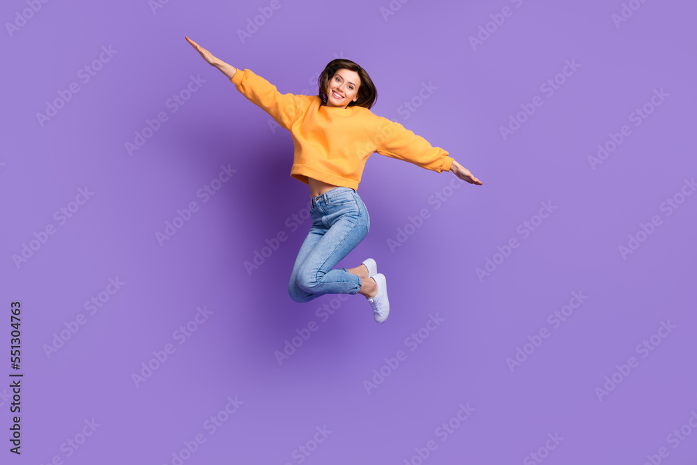 Full length size photo of charming nice woman flying like bird carefree relax vacation trip weekend chill isolated on bright violet color background