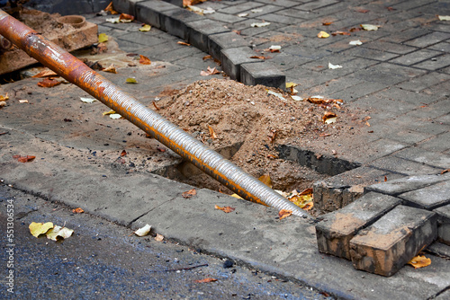 Trenchless laying of communications, water pipes and fiber optic with horizontal directional drilling technology machine. HDD drill rig, drilling under sidewalk. Underground pipe laying..