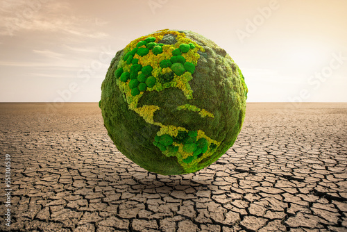 Fototapeta Naklejka Na Ścianę i Meble -  Green planet earth on desert. Symbol of global warming and climate change
