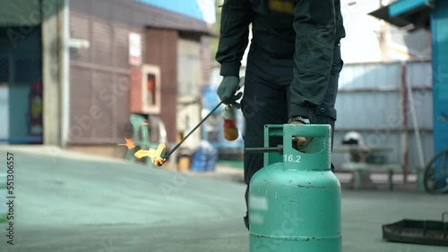 Man teaches or training how to close fire extinguishers to extinguish fires from LPG cooking gas tanks in house or industry for safety.