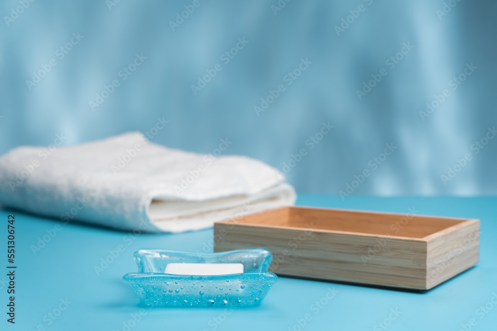 White Soap bar on soap dish and cotton towels on counter table in the bathroom White Soap bar on soap dish and cotton towels on counter table in the bathroom