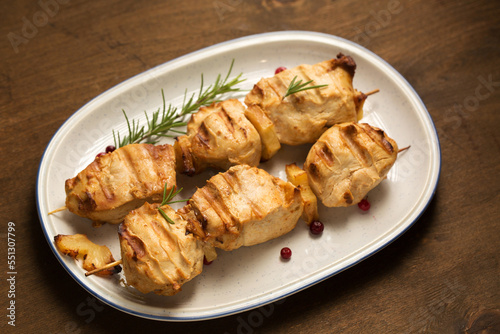 Chicken kebab with lingonberry on a dark background